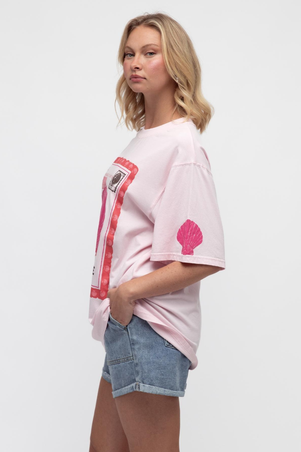 Woman wearing a pink t-shirt with graphics on a white background