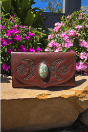 Dark Brown Antique style leather wallet with hand tooled crescent moons and flowers surrounding a stone.