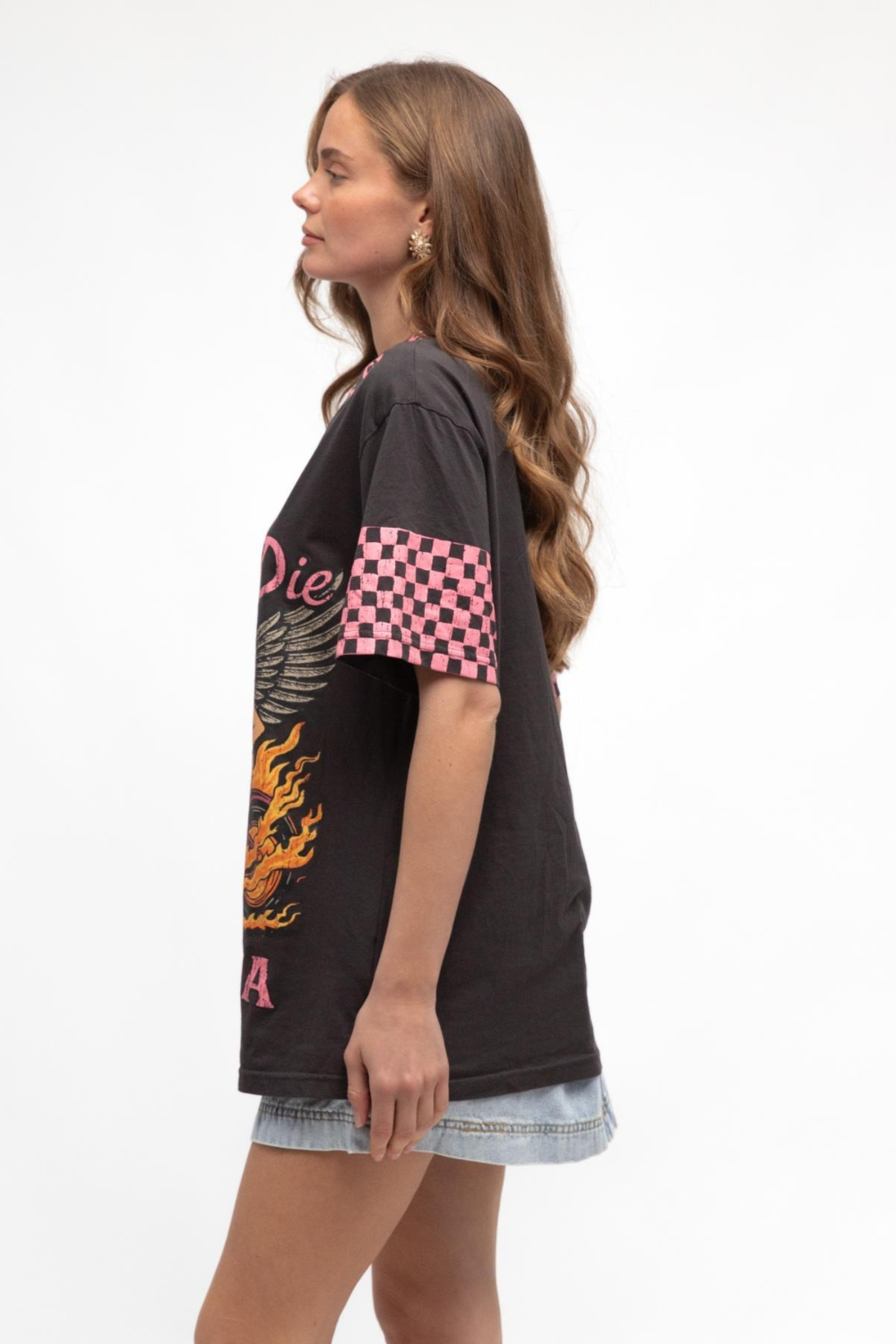 Woman wearing a black t-shirt with colorful designs on a white background