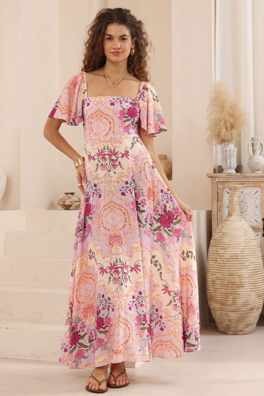 Woman wearing a floral dress in a home setting