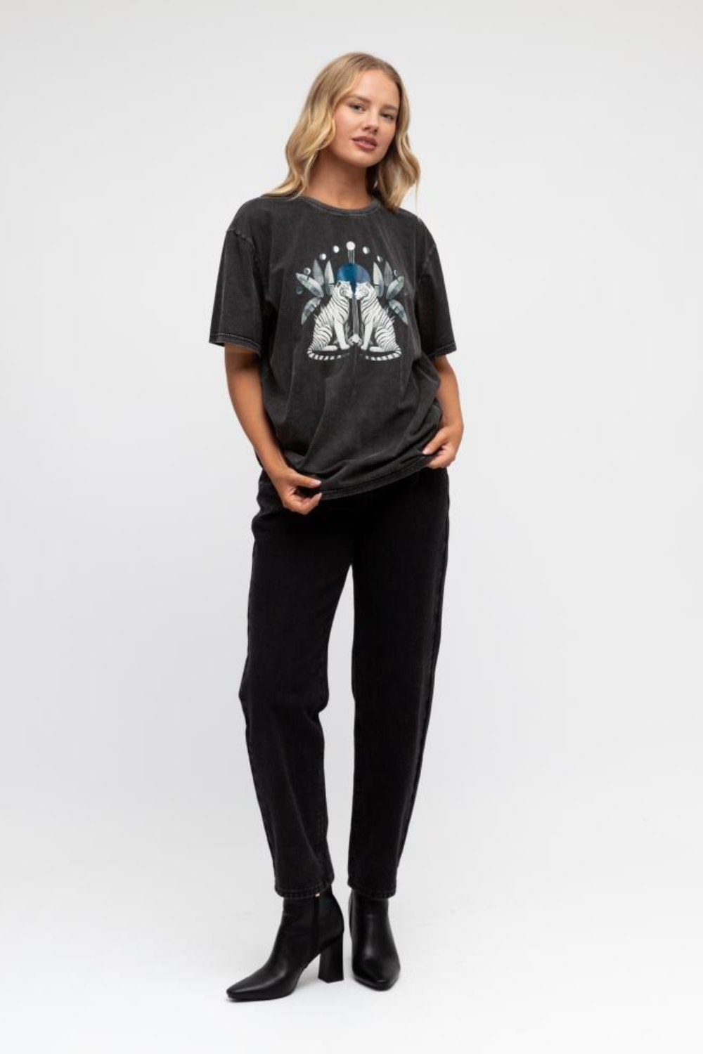 Woman wearing a black t-shirt with a graphic design on a white background