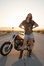 With vintage motorcycle at sunset